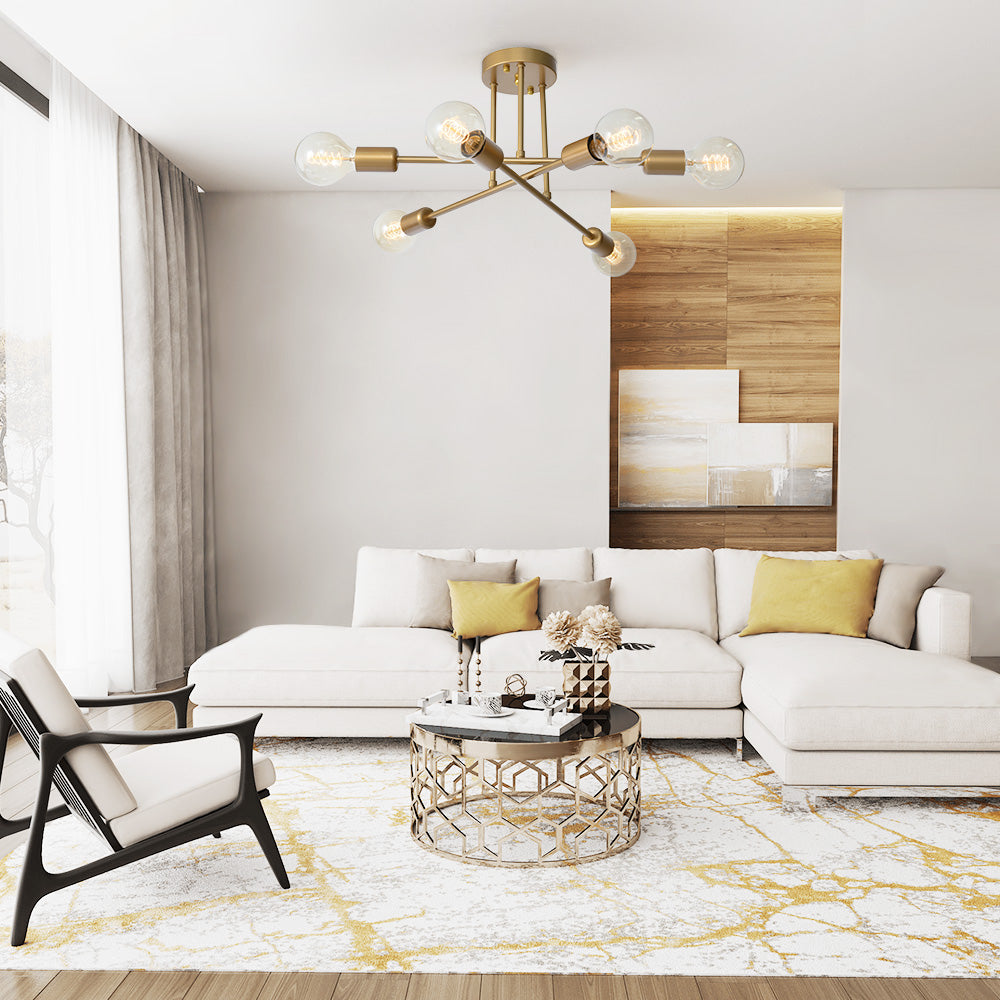 6-arm gold starburst ceiling lamp illuminating a bright, spacious living room with a white sectional sofa