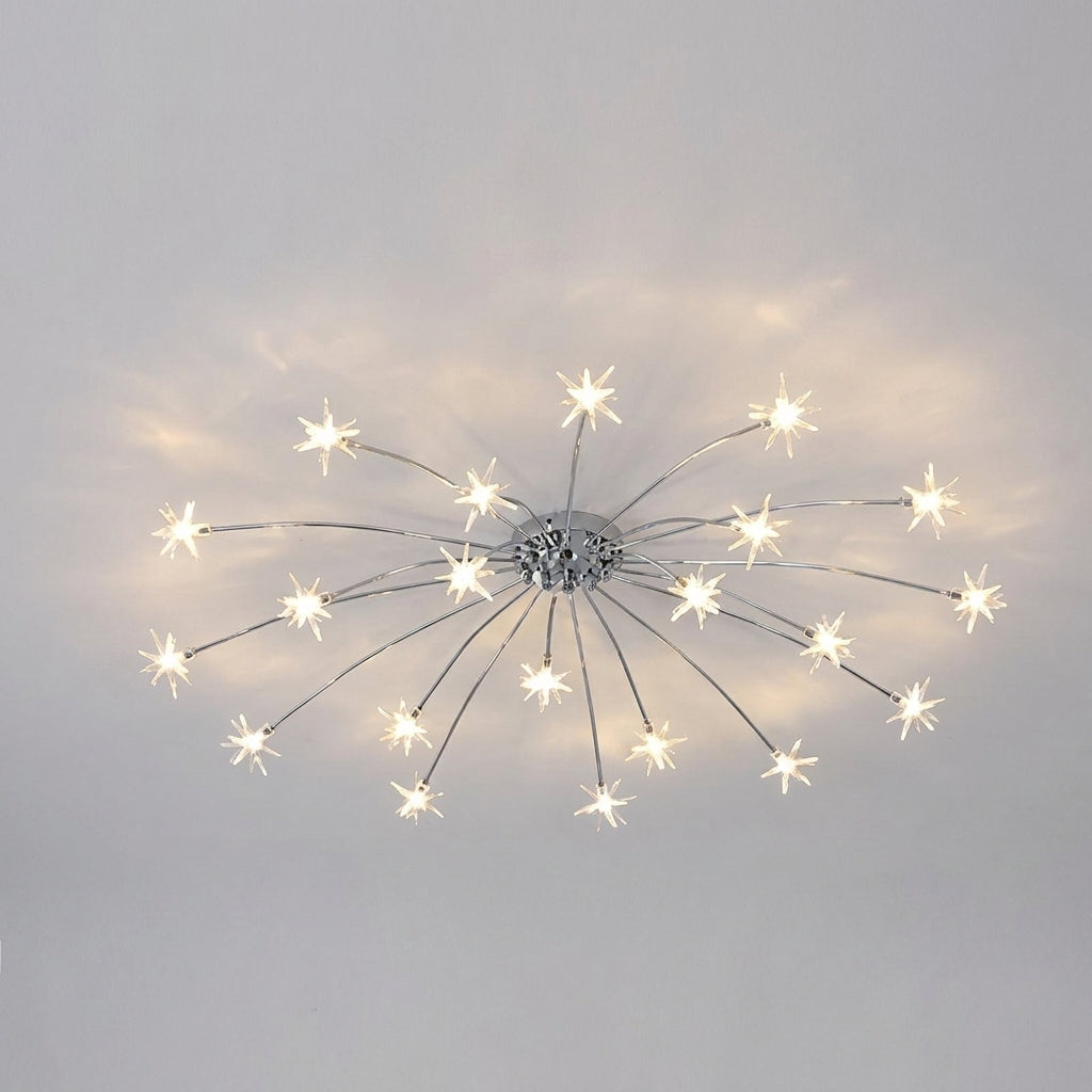 A modern ceiling light fixture with a silver chrome starburst design, featuring multiple thin radiating arms ending in bright white star-shaped bulbs, shown against a plain light grey background.