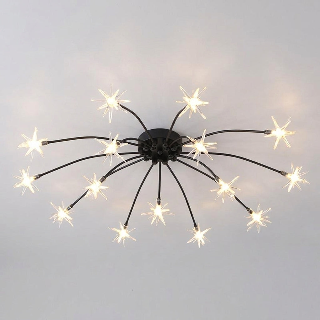A ceiling-mounted light fixture with a black central hub and multiple thin arms ending in starburst-shaped bulbs that glow warm white against a plain light grey ceiling.