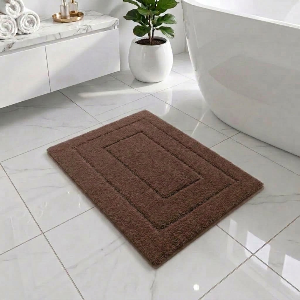 a brown rectangular bath mat laying on the bathroom floor white tiles next to a bath tub and floating cabinet
