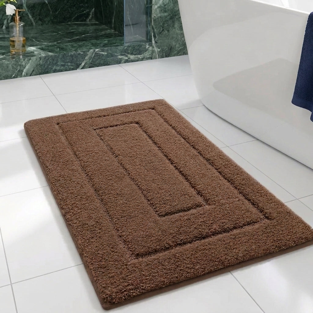 brown rectangular bath matt laying on white tiles next to a green tiled shower cabin and a white bathtub 