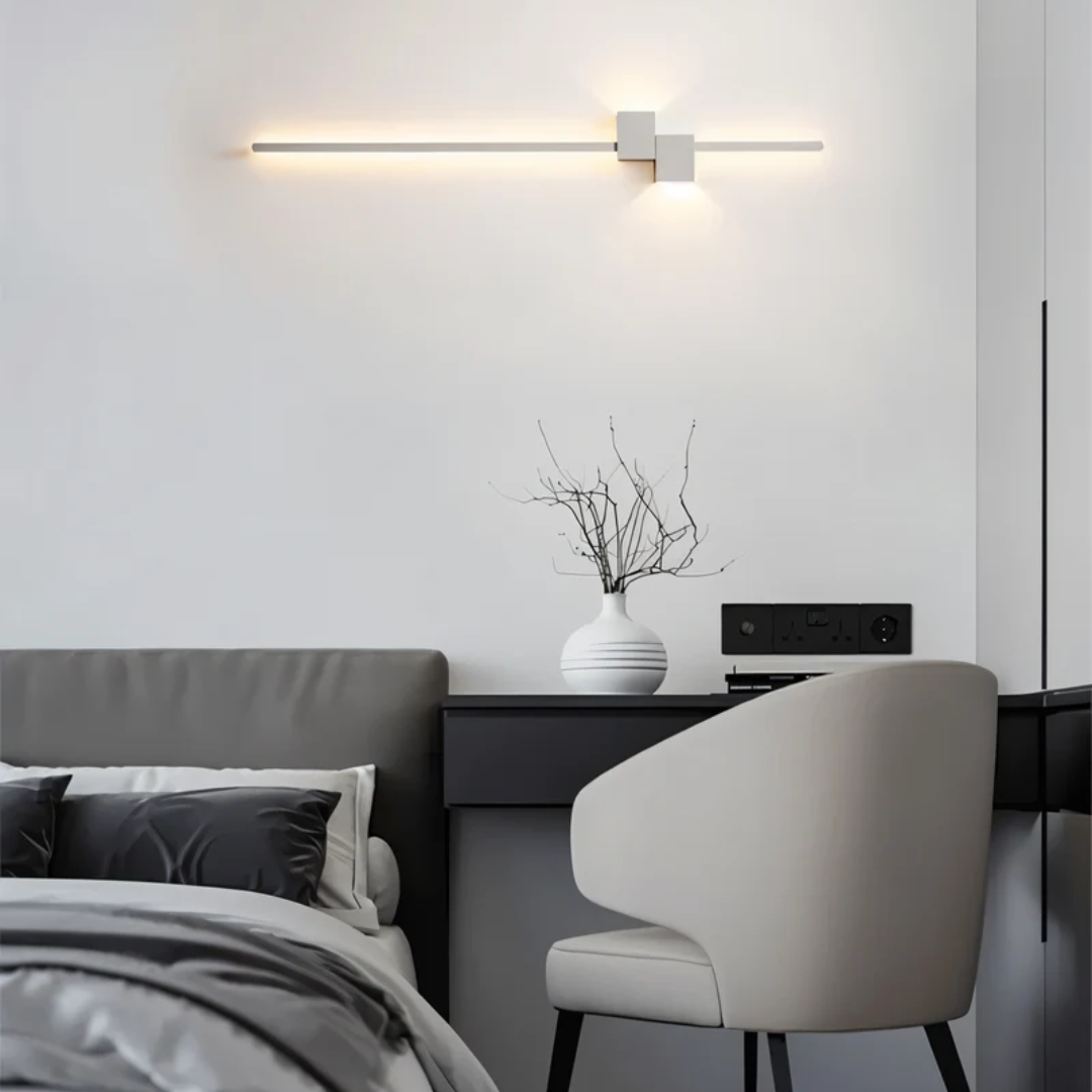 aexi white horizontal linear LED wall light illuminating a minimalist modern desk and vanity area