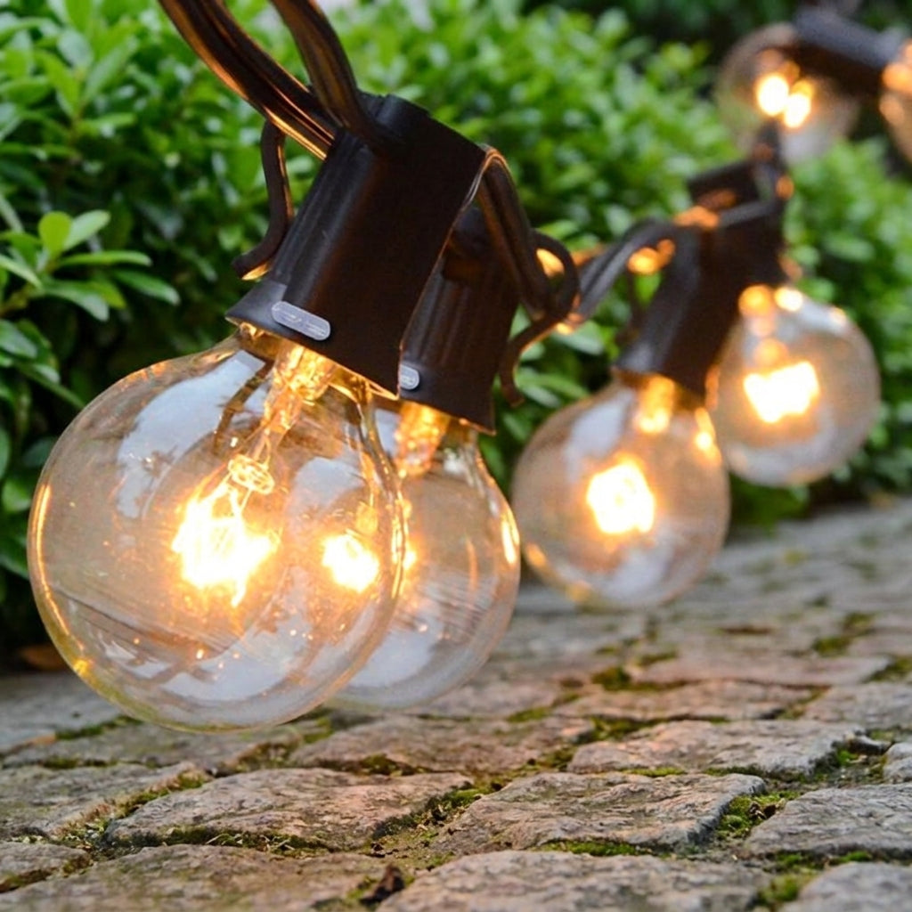 Close-up of clustered Afqo string light bulbs resting on a stone ledge