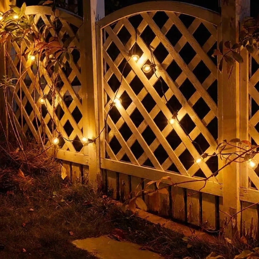 Afqo solar string lights draped across a wooden lattice garden gate