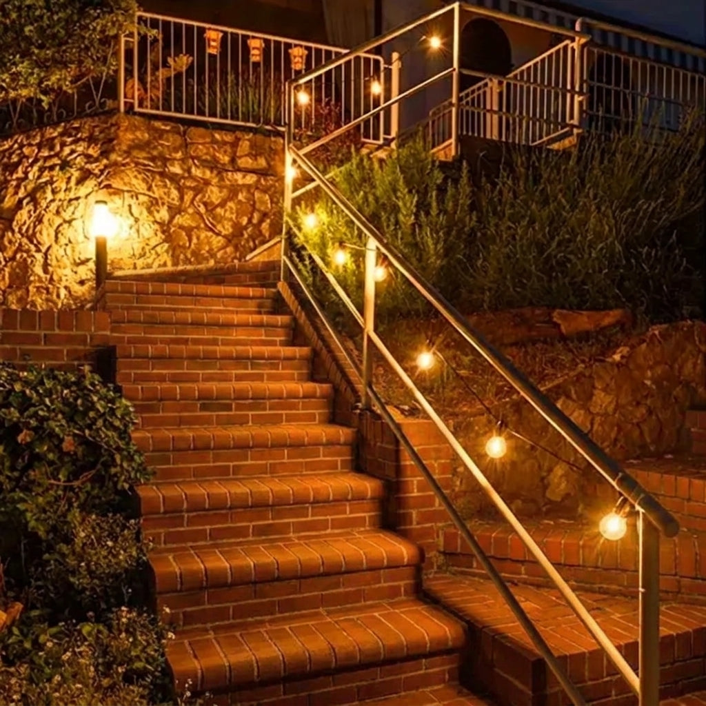Afqo solar string lights illuminating a brick outdoor staircase and railing at night