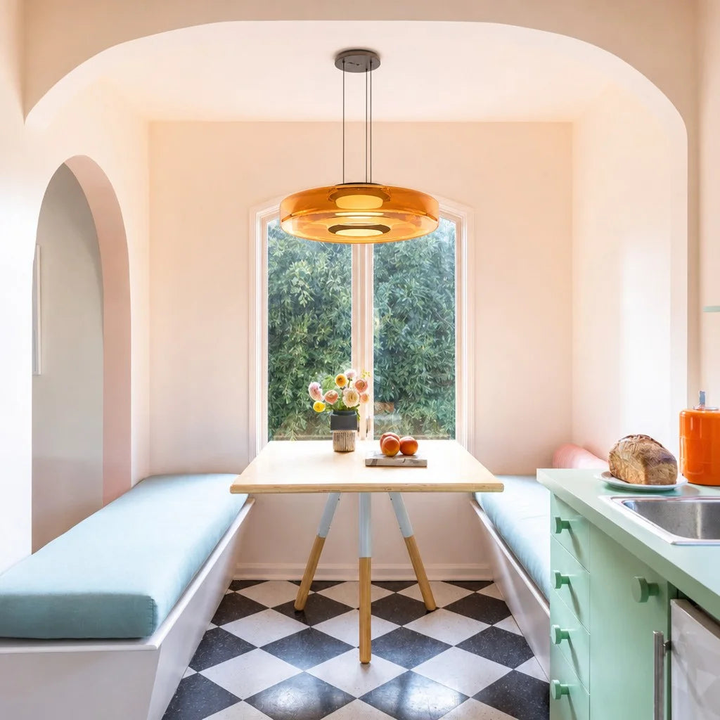 Amber single-layer glass pendant light styled over a dining table in a sunlit room