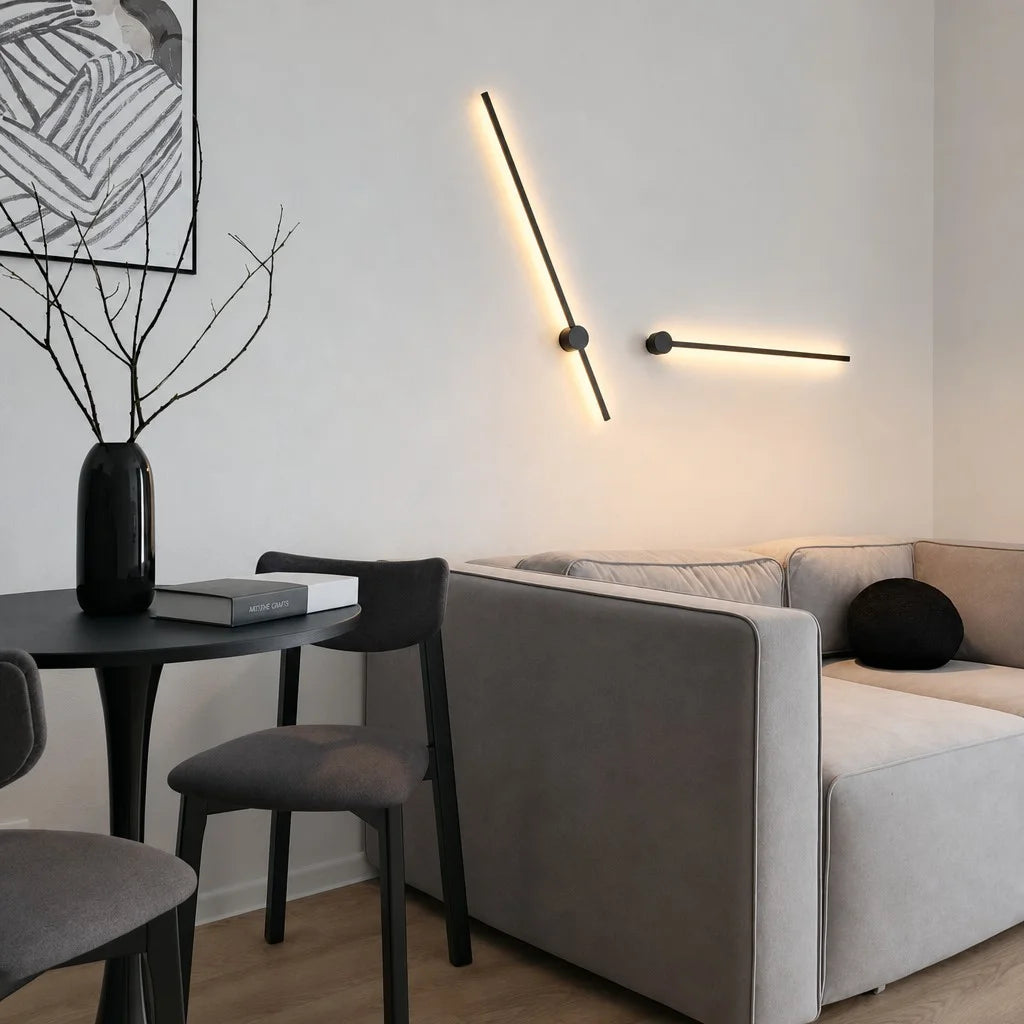 Sleek linear wall sconce rotated at a dynamic 45-degree angle above a modern grey sofa