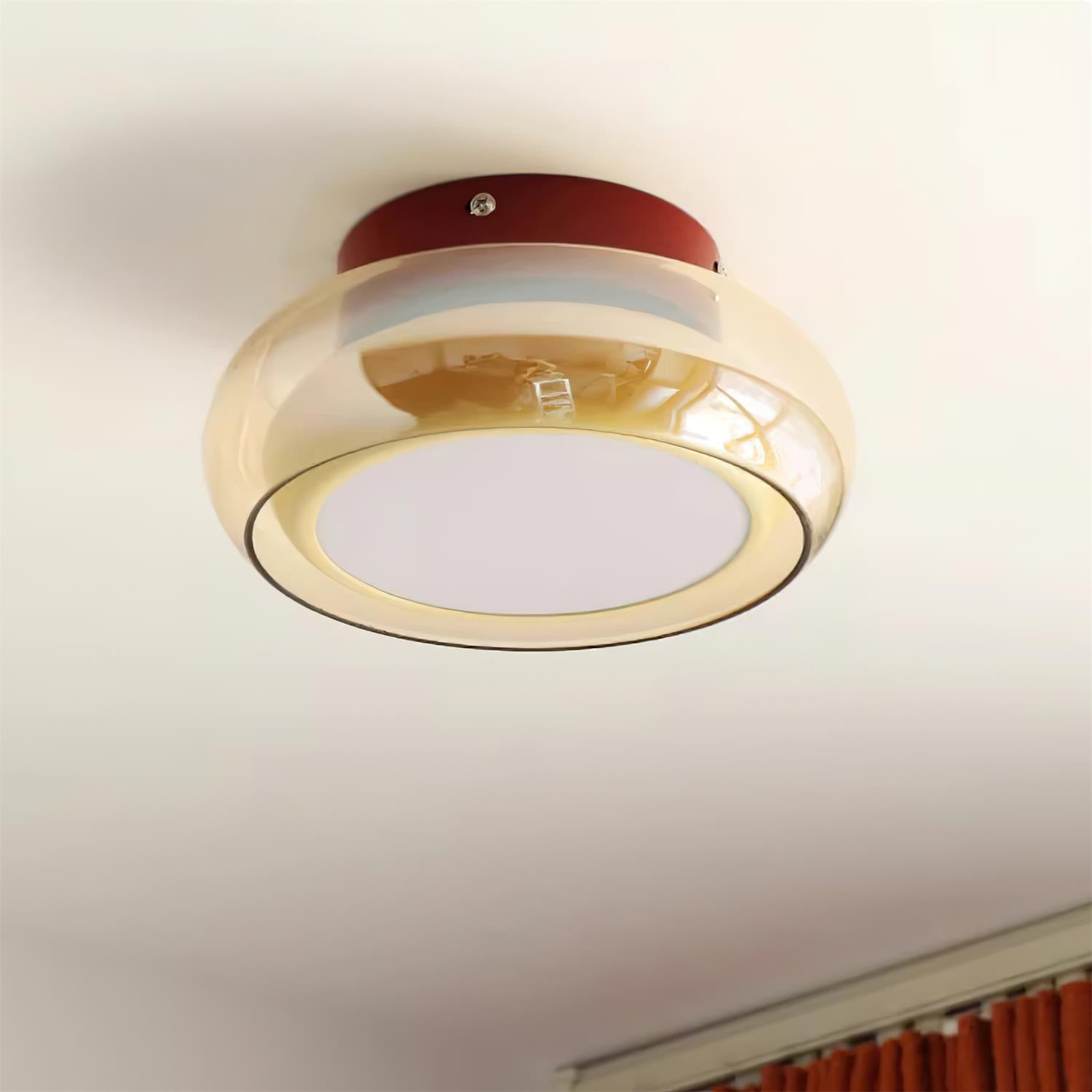 Angled view of the red and amber glass ceiling fixture installed on a white ceiling