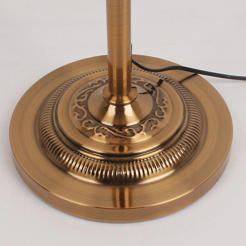 Close-up detail of the heavy, ornate antique brass finish floor lamp base