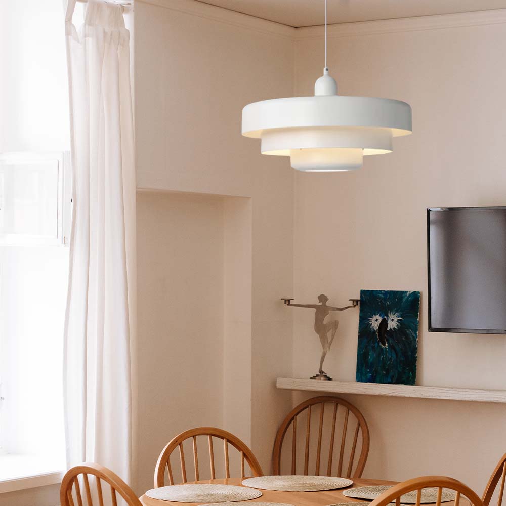 Classic balel white mid-century tiered pendant illuminating a traditional wooden dining setup