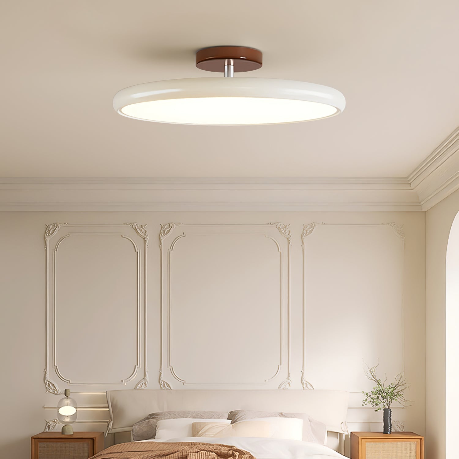 Beige rotatable flush mount ceiling light illuminating a stylish bedroom with wall panelling