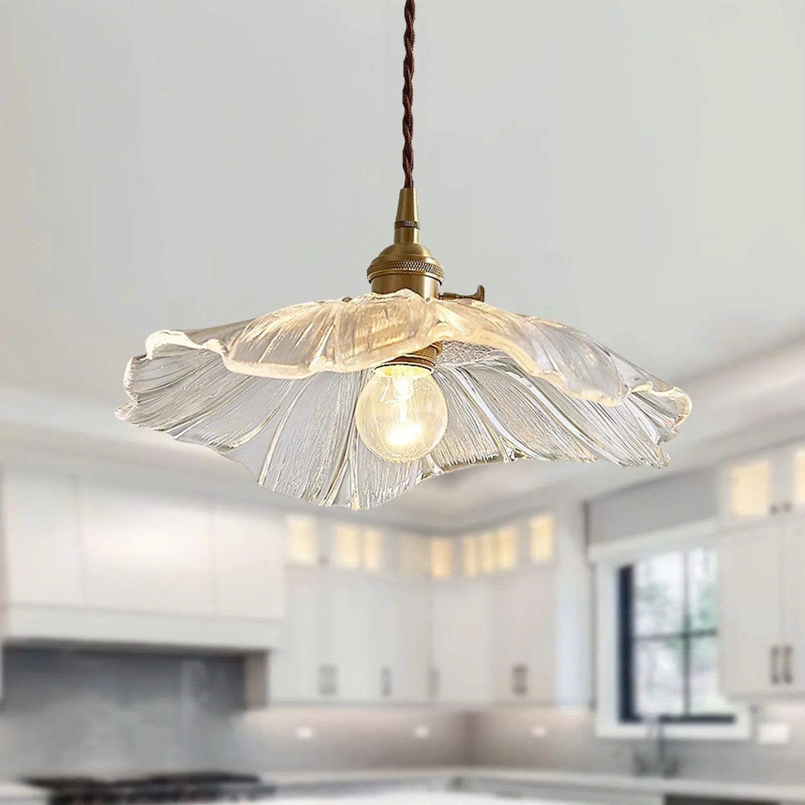 Clear glass bila floral pendant light providing elegant illumination over a white kitchen island