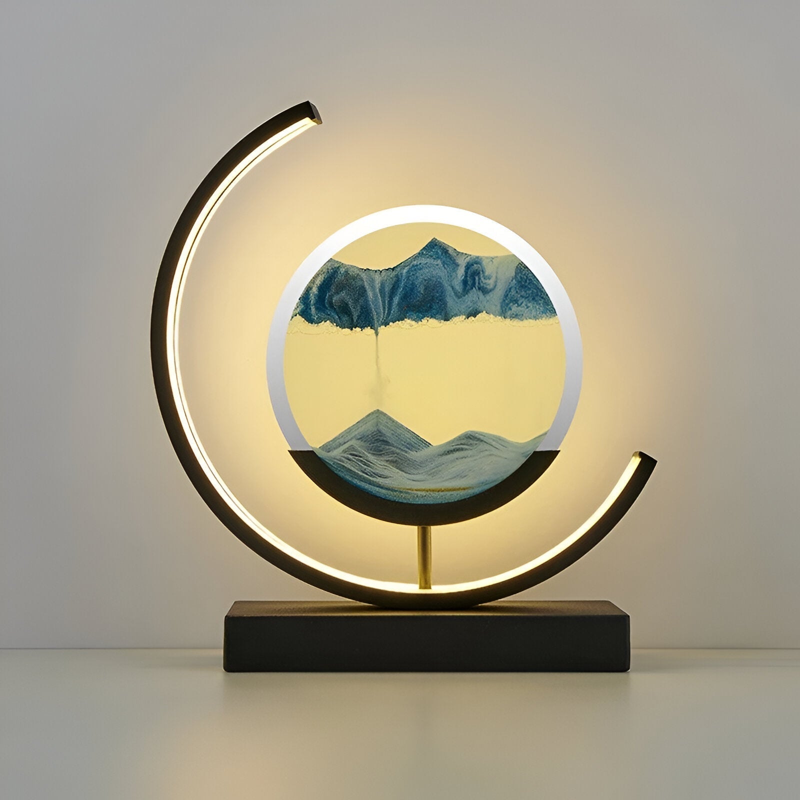 Black circular LED moving sand art lamp featuring a serene blue sand landscape