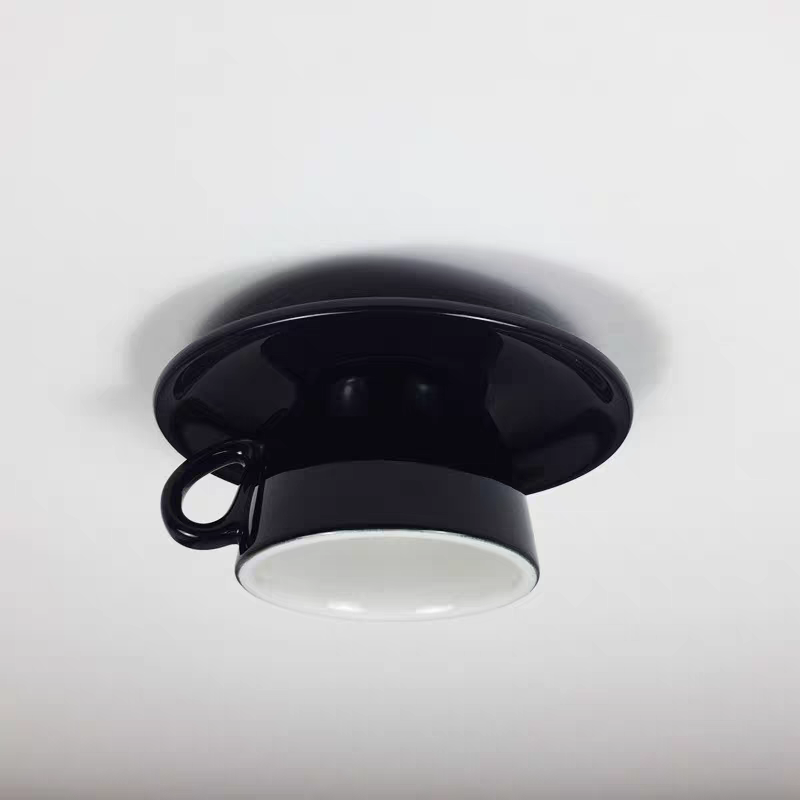 Sleek black ceramic teacup ceiling light for a modern, playful aesthetic
