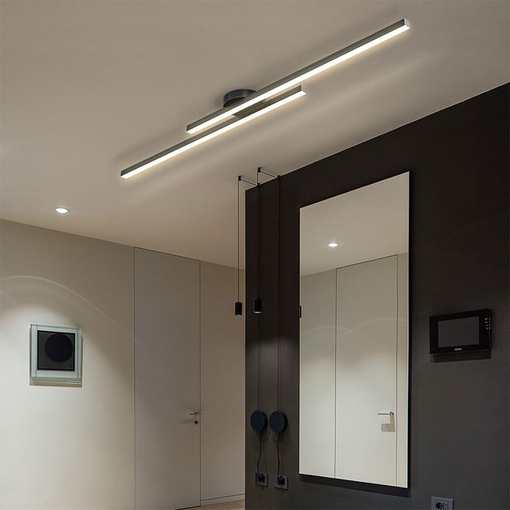 Black double-bar ceiling light acting as a modern centrepiece over a dining area