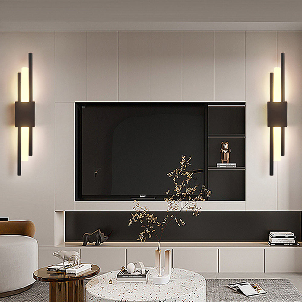 Black geometric wall lights installed on either side of a living room television for ambient viewing light