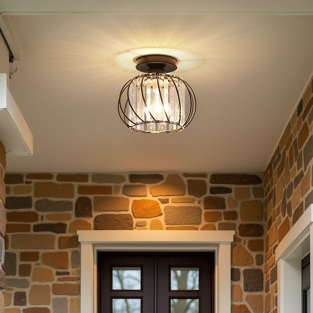 Modern black glass globe flush mount light accenting a rustic stone wall interior
