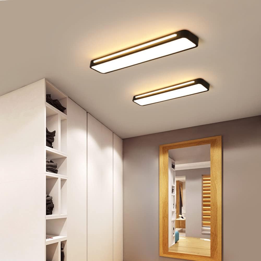 Pair of black ultra-thin linear LED ceiling lights illuminating a modern walk-in wardrobe