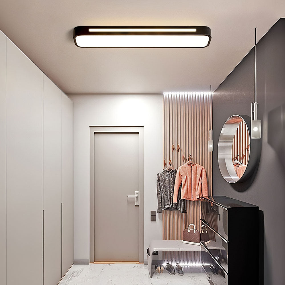 Modern black linear flush mount ceiling light providing bright ambient lighting in a sleek corridor