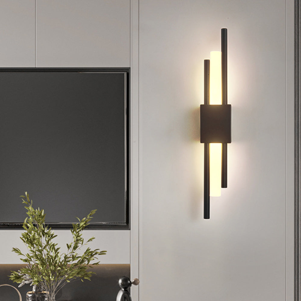 Black linear wall lamp providing elegant accent lighting next to a tv
