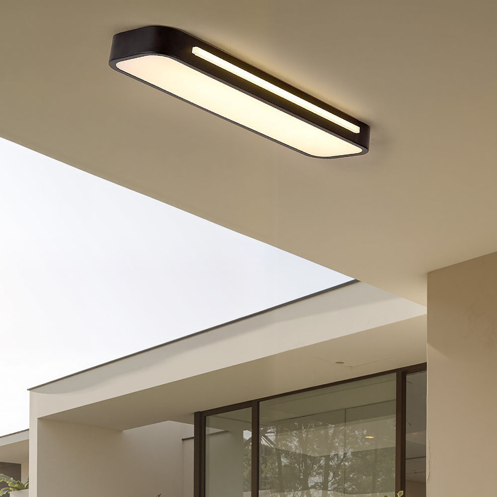 Minimalist black linear LED ceiling lamp installed in a modern architectural living space