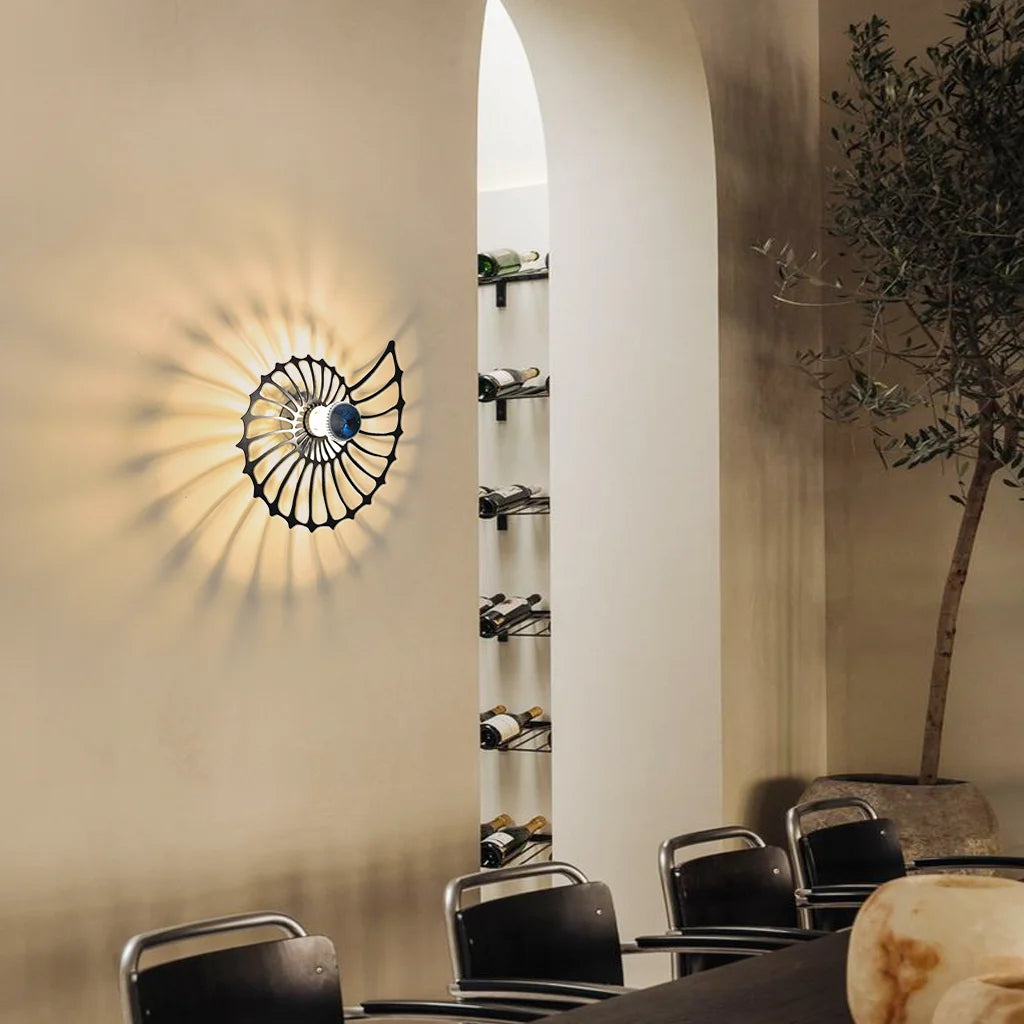 Black Nautilus accent light mounted next to an arched doorway and modern wine rack
