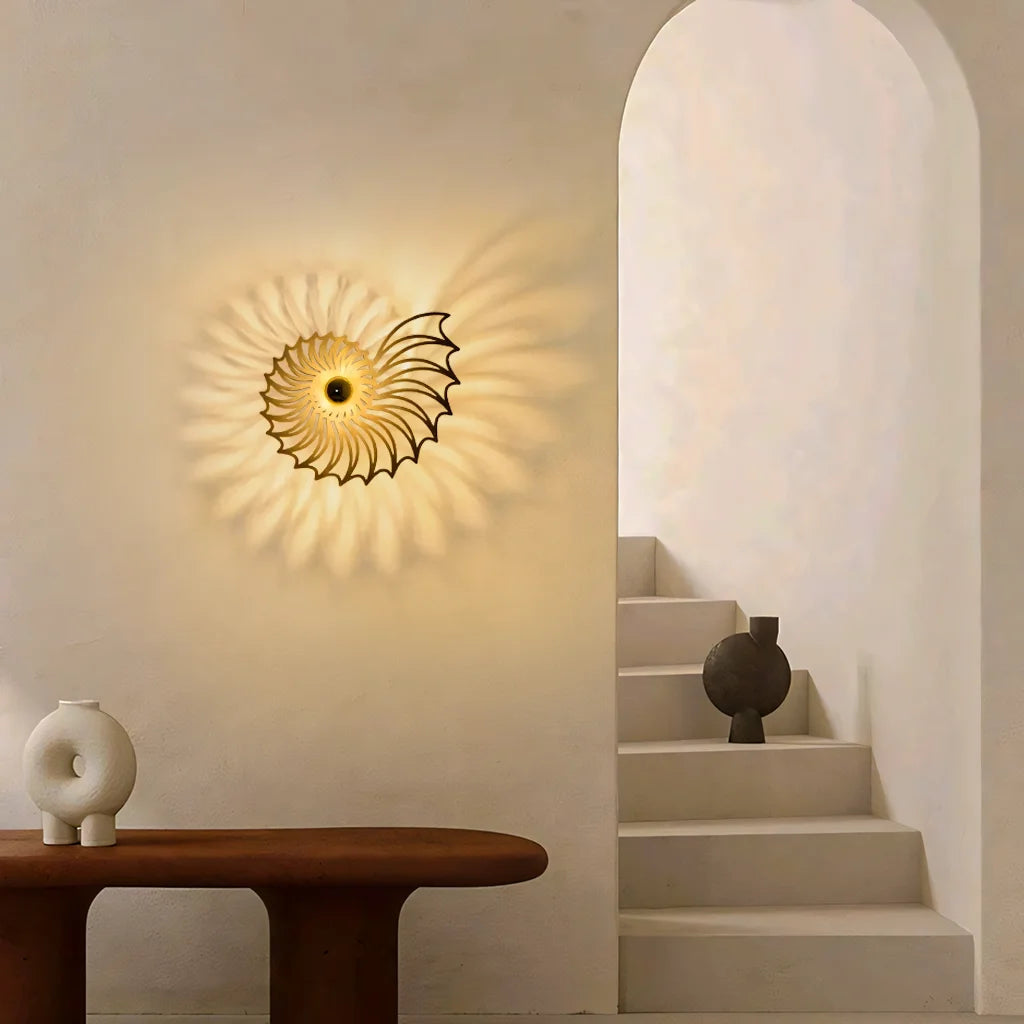 Black Nautilus wall sconce providing atmospheric shadow lighting near a modern minimalist staircase