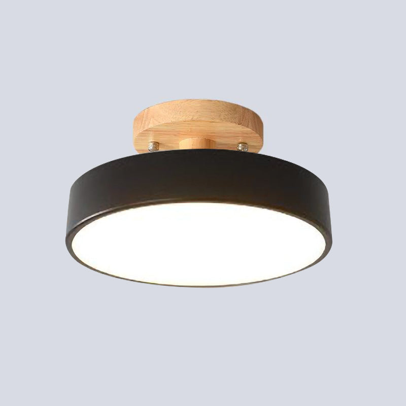 Isolated view of the bold black Nordic wood ceiling lamp with its glowing acrylic diffuser
