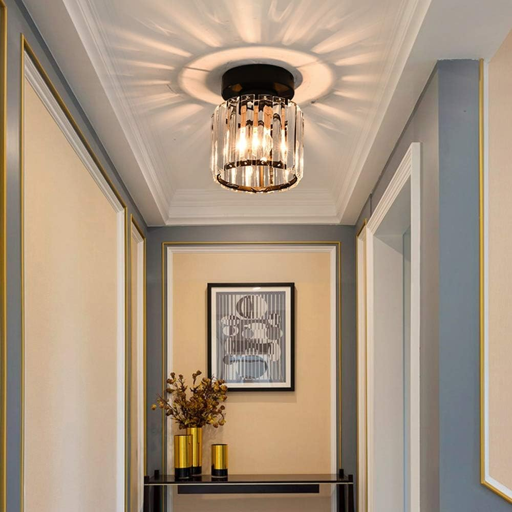 Black round crystal ceiling light providing ambient starburst illumination in a dark corridor
