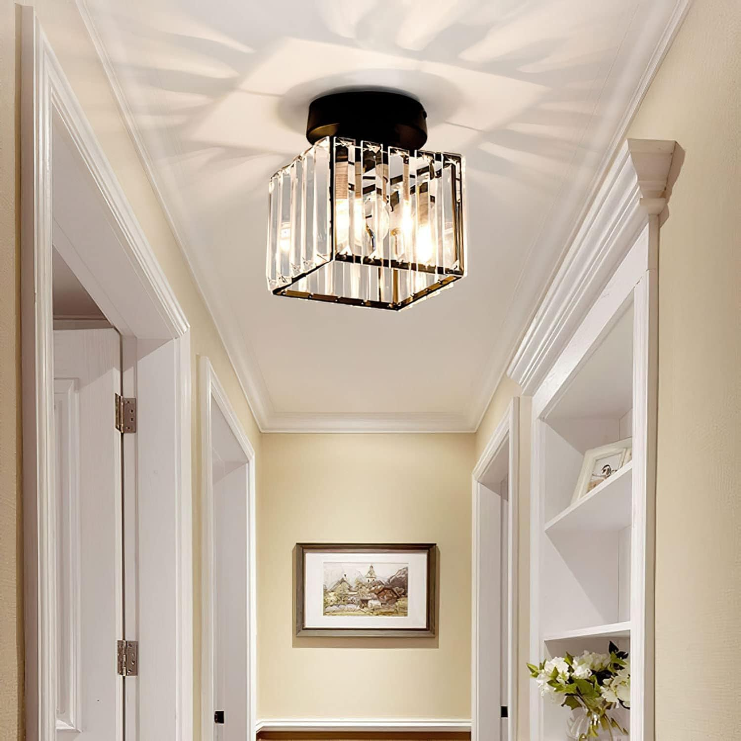 Modern black square crystal flush mount light illuminating a bright home entryway