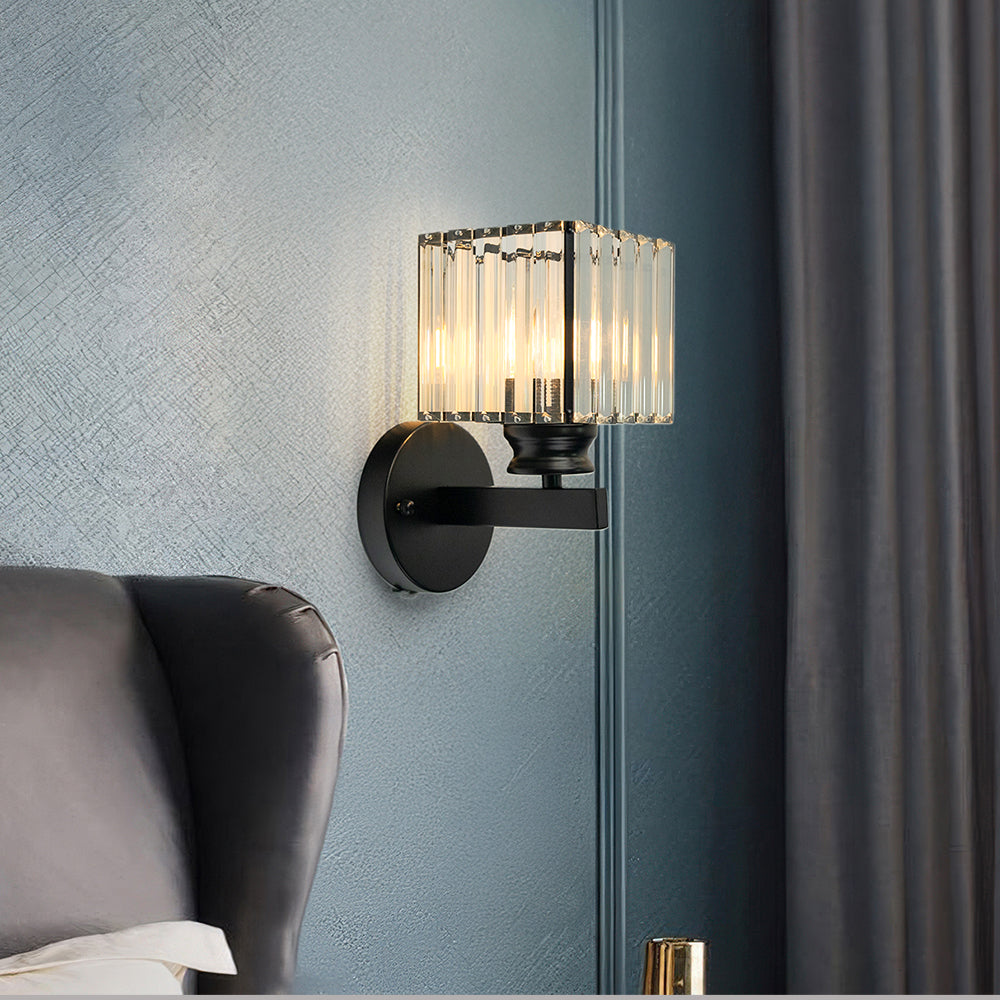 Black square crystal wall sconce contrasting beautifully against a moody dark blue interior wall
