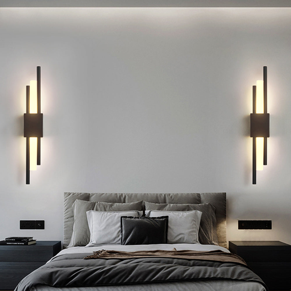 Pair of black staggered LED wall sconces symmetrically framing a bed in a contemporary bedroom