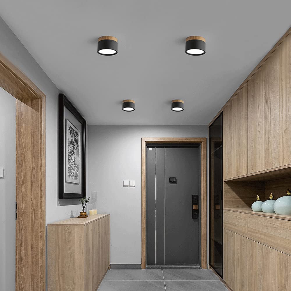 Black aluminium cylinder surface spotlights installed on a hallway ceiling