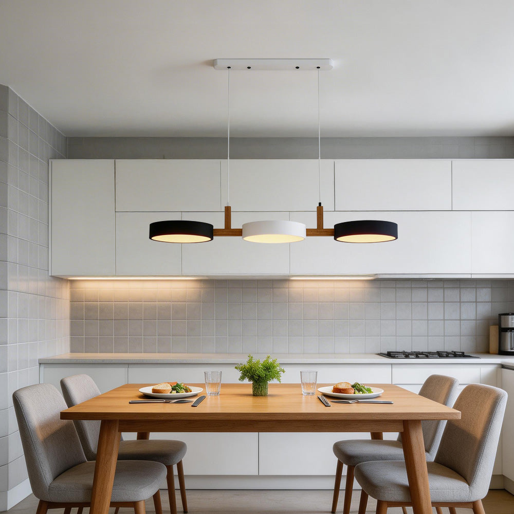 Black, white, and black linear pendant contrasting beautifully over a wooden dining table