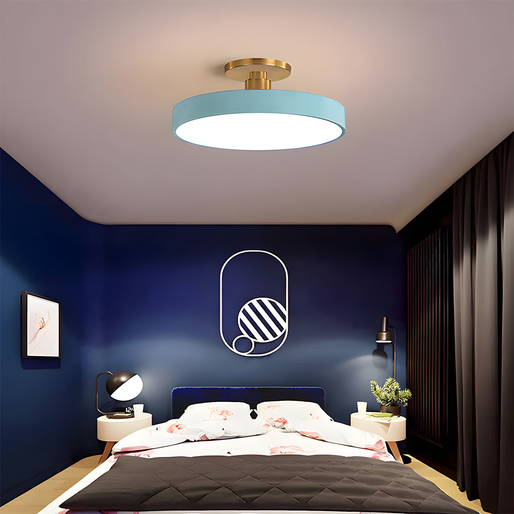 blue drum ceiling light creating a striking focal point in a moody, dark blue bedroom