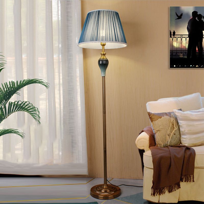Blue pleated fabric standing floor lamp adding an elegant touch of colour to a living room