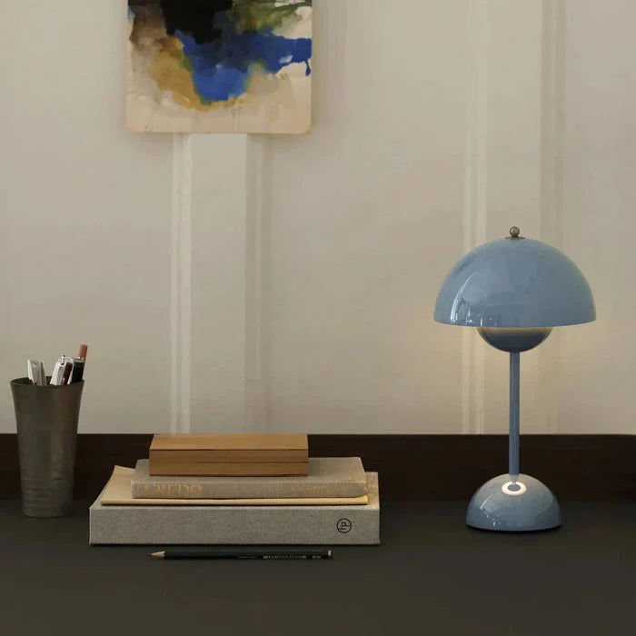 blue rechargeable mushroom desk light adding a subtle pop of retro colour to a dark workspace