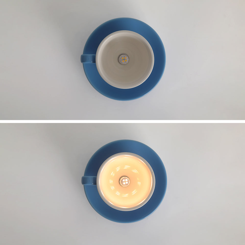 Top-down view of the blue teacup ceiling light showing the unlit and illuminated G4 bulb socket