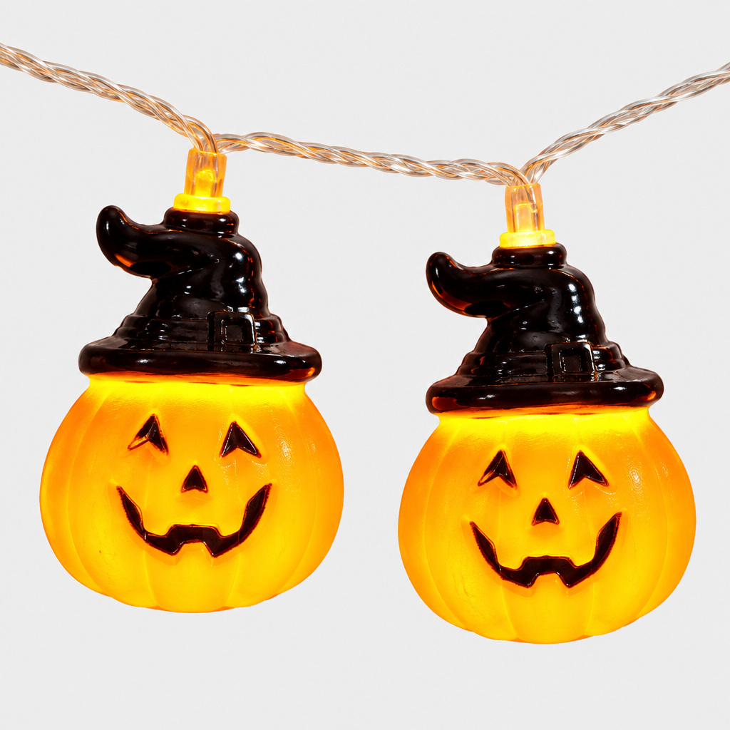 Close-up detail of two glowing pumpkin-shaped LED bulbs with witch hat toppers on the Brimsparks string light