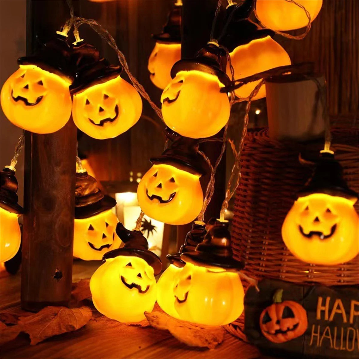 Brimsparks pumpkin-shaped LED string lights glowing beside a rustic Happy Halloween sign