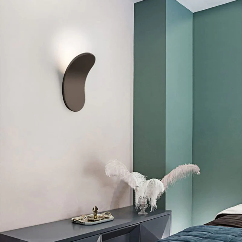 Brown architectural wall sconce installed on a light wall next to a teal accent wall