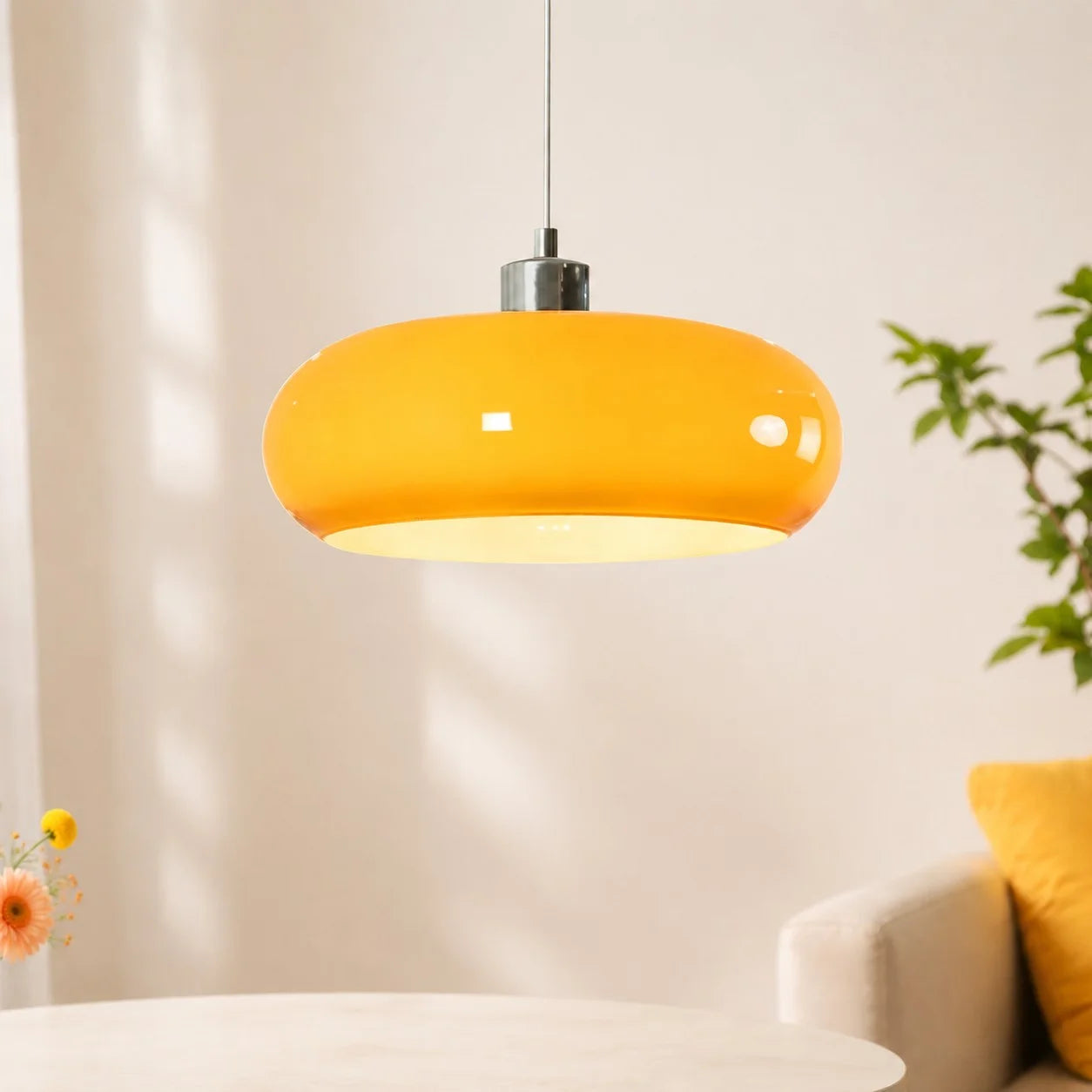 brown glass dome pendant light hanging above a white table in a bright, sunlit modern room