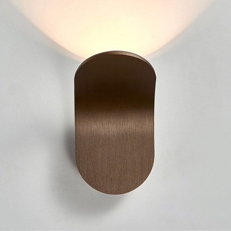 Front profile view of the sleek brown Nordic curved wall sconce.