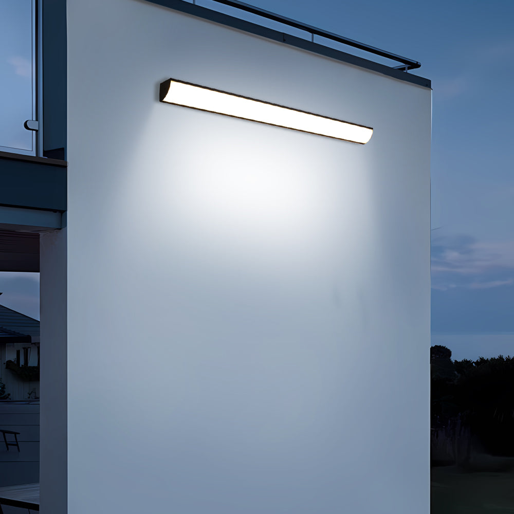 Cool white linear bubce LED outdoor wall light illuminating a contemporary home facade