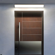 bubce modern front-lit linear LED outdoor wall light mounted horizontally above a sleek wooden front door