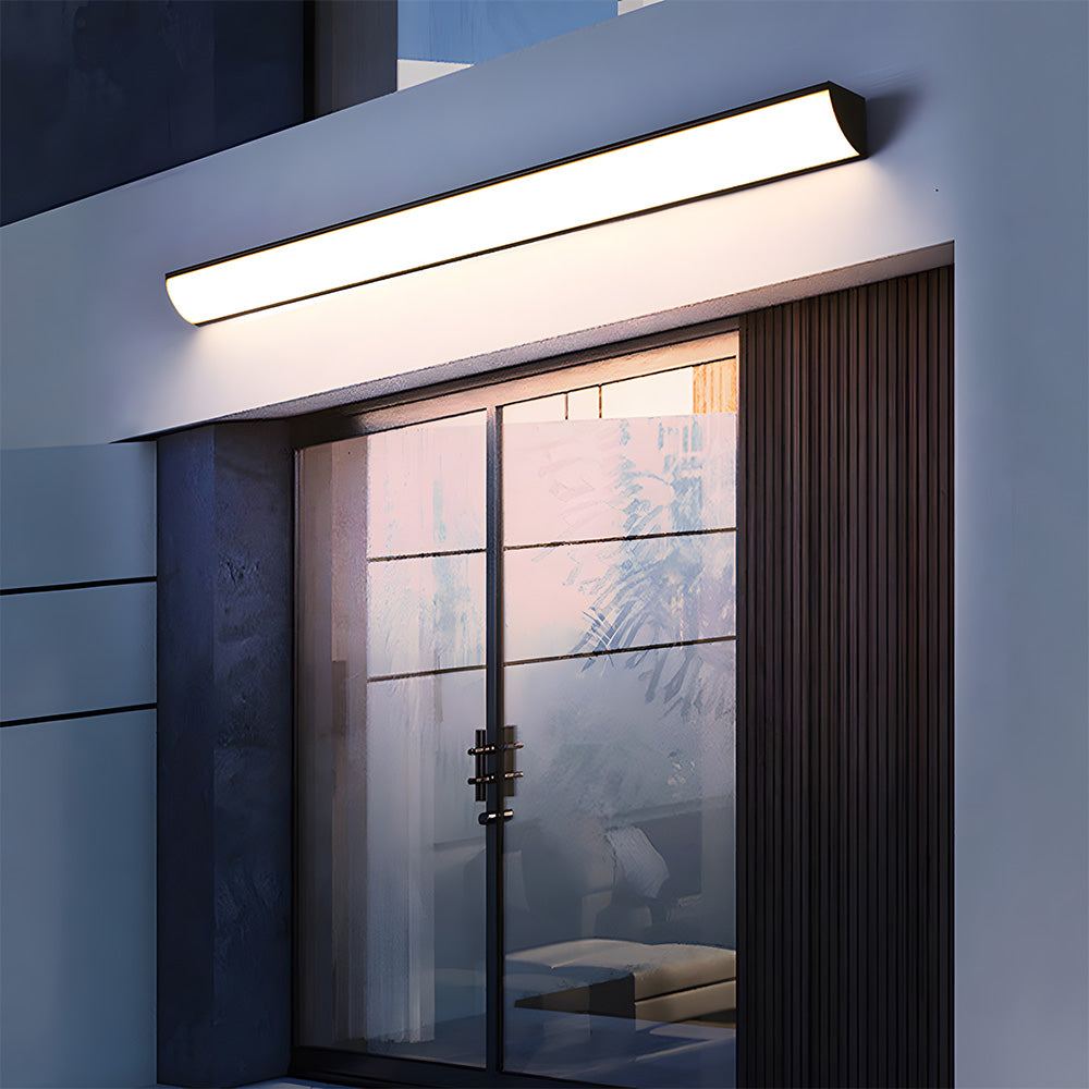Long outdoor bubce LED wall sconce highlighting modern glass patio sliding doors