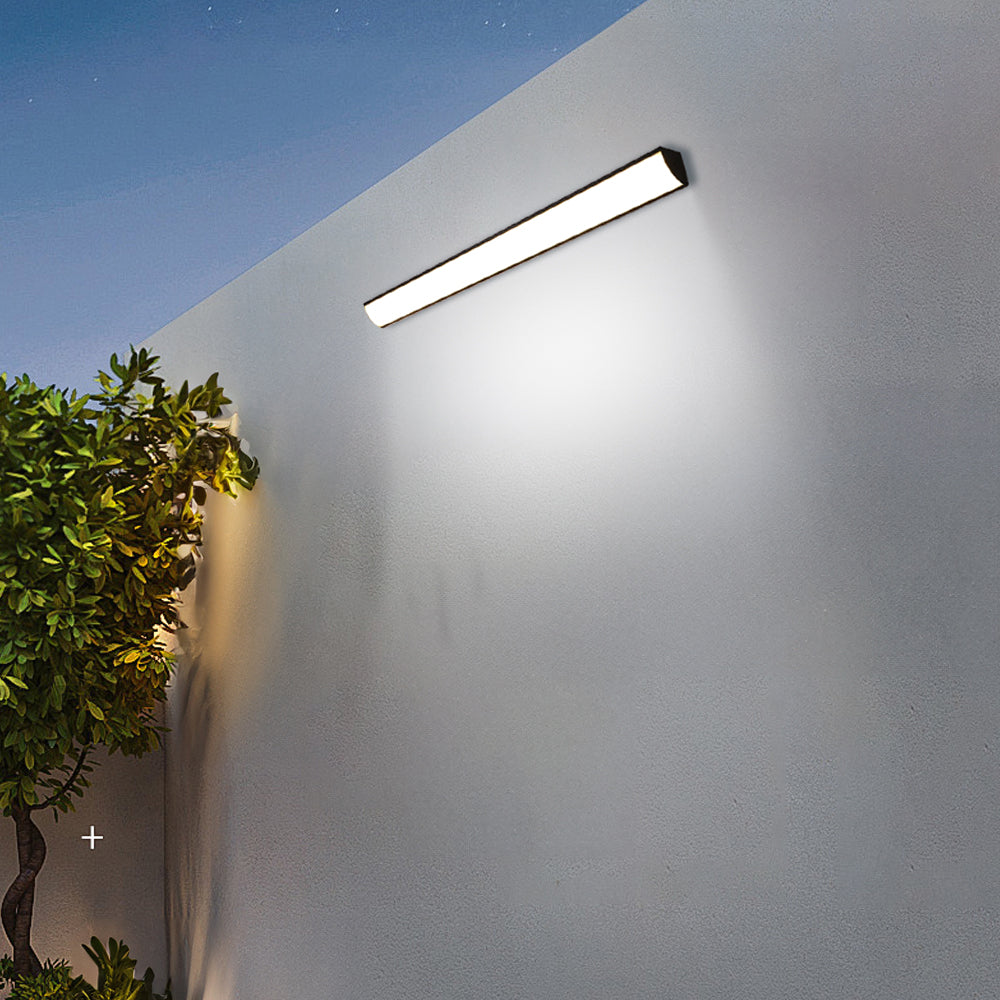 Waterproof linear bubce LED sconce illuminating an exterior architectural wall at night
