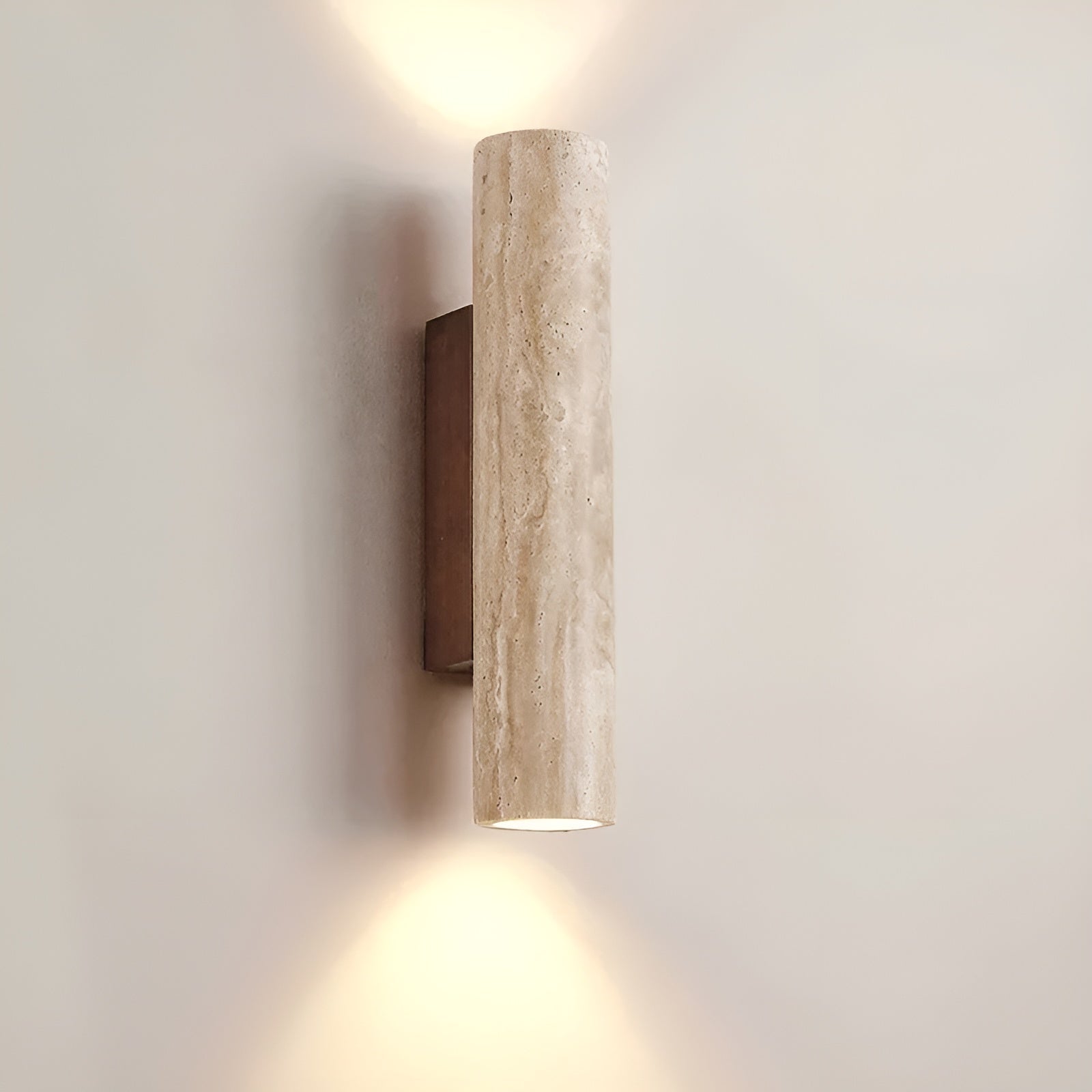 Japandi style natural stone bura wall light illuminating a minimalist interior with its dual emission beam