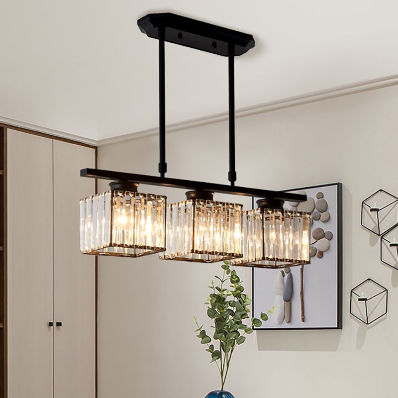 Black 3-light square ribbed glass butel chandelier illuminating a modern dining room.