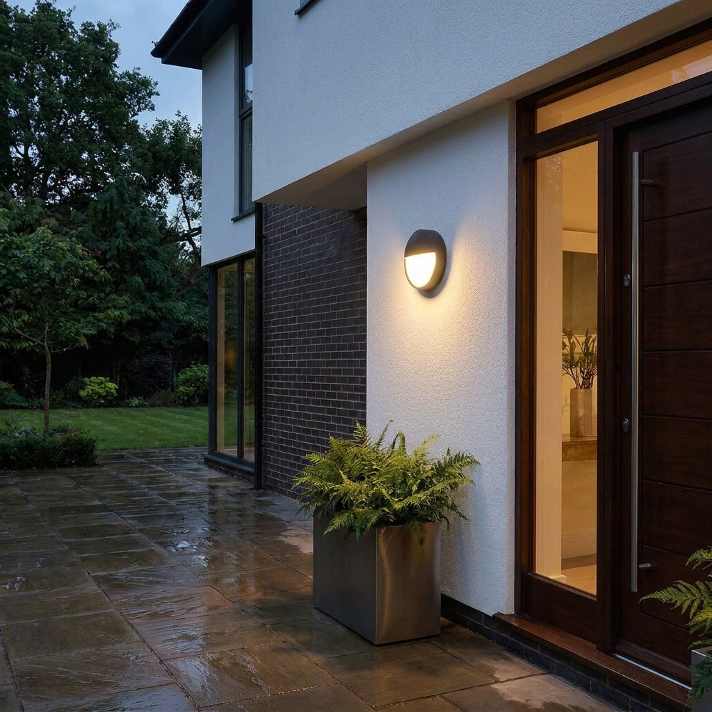 Byrzi outdoor wall light beside a modern entrance door in the rain